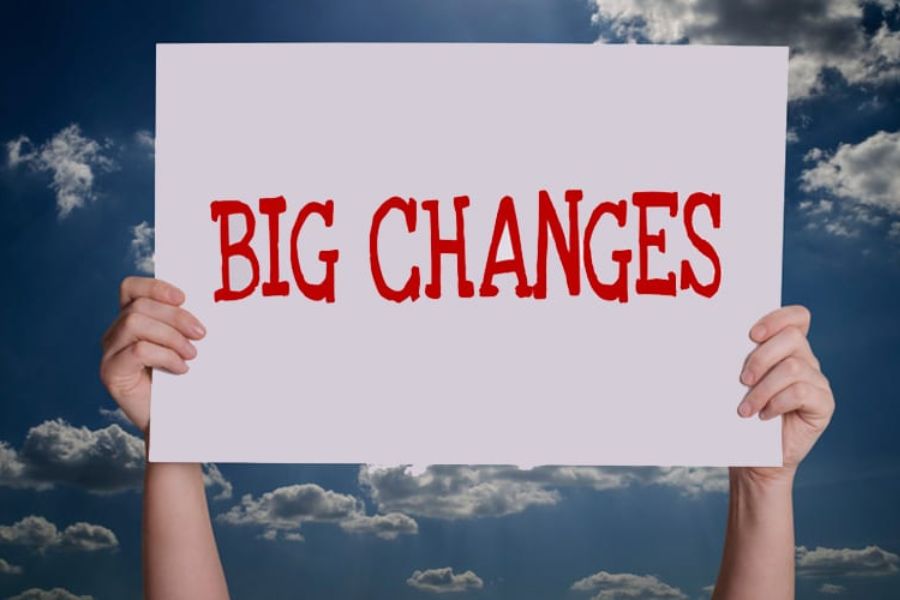 hands holding a sign that says Big Changes