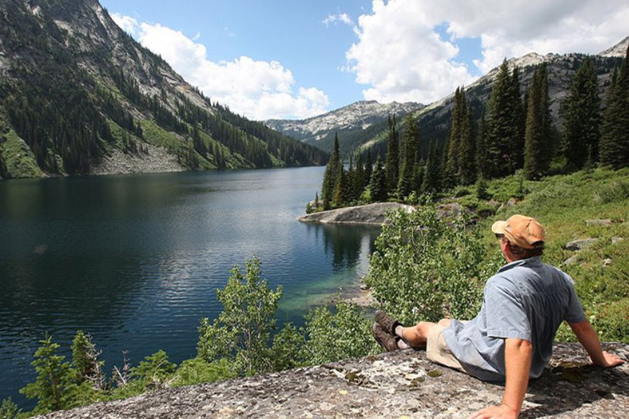 image of a hiker looking over a lake below