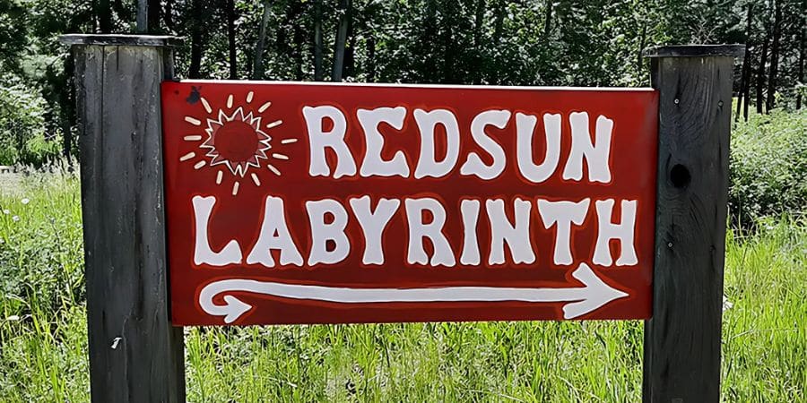 image of sign for red sun labyrinth in victor, mt